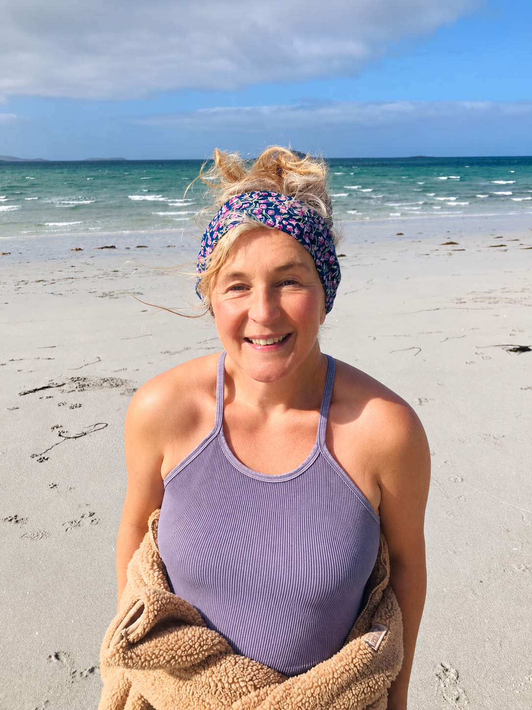 Gail smiling on a beach