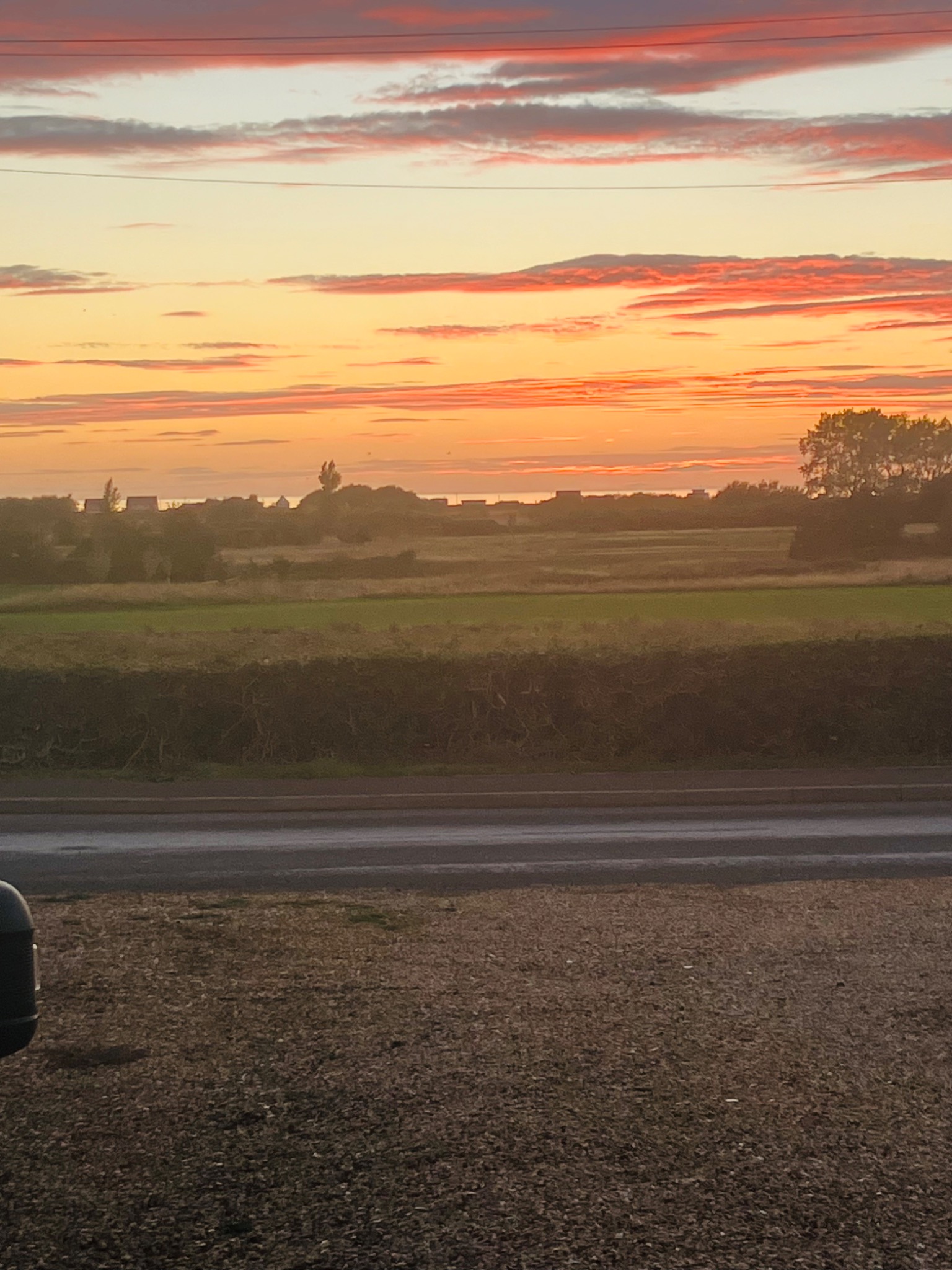 Sunset over the sea and fields viewed from Gail's home in Heacham