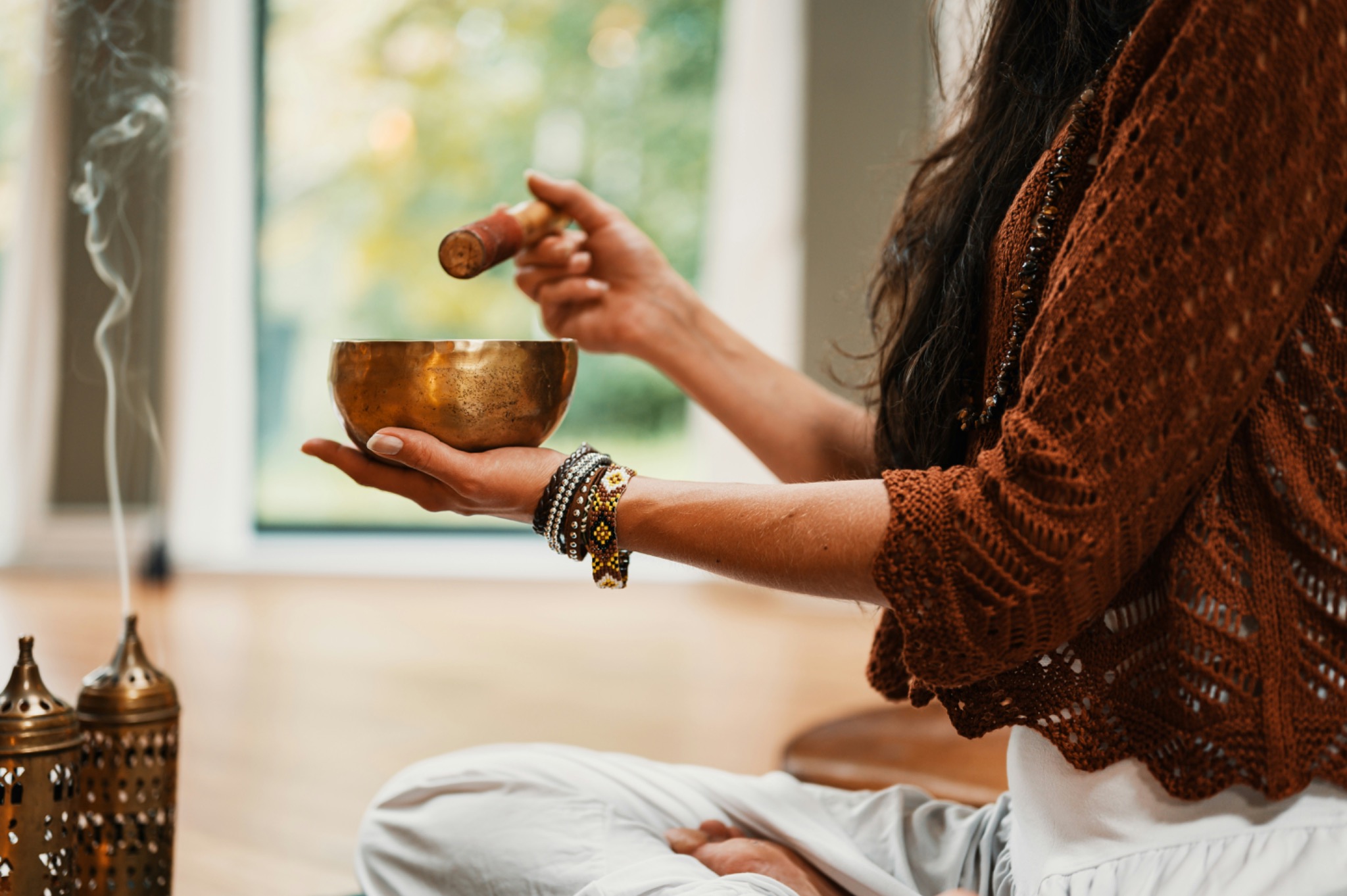 Woman playing a singing bowl