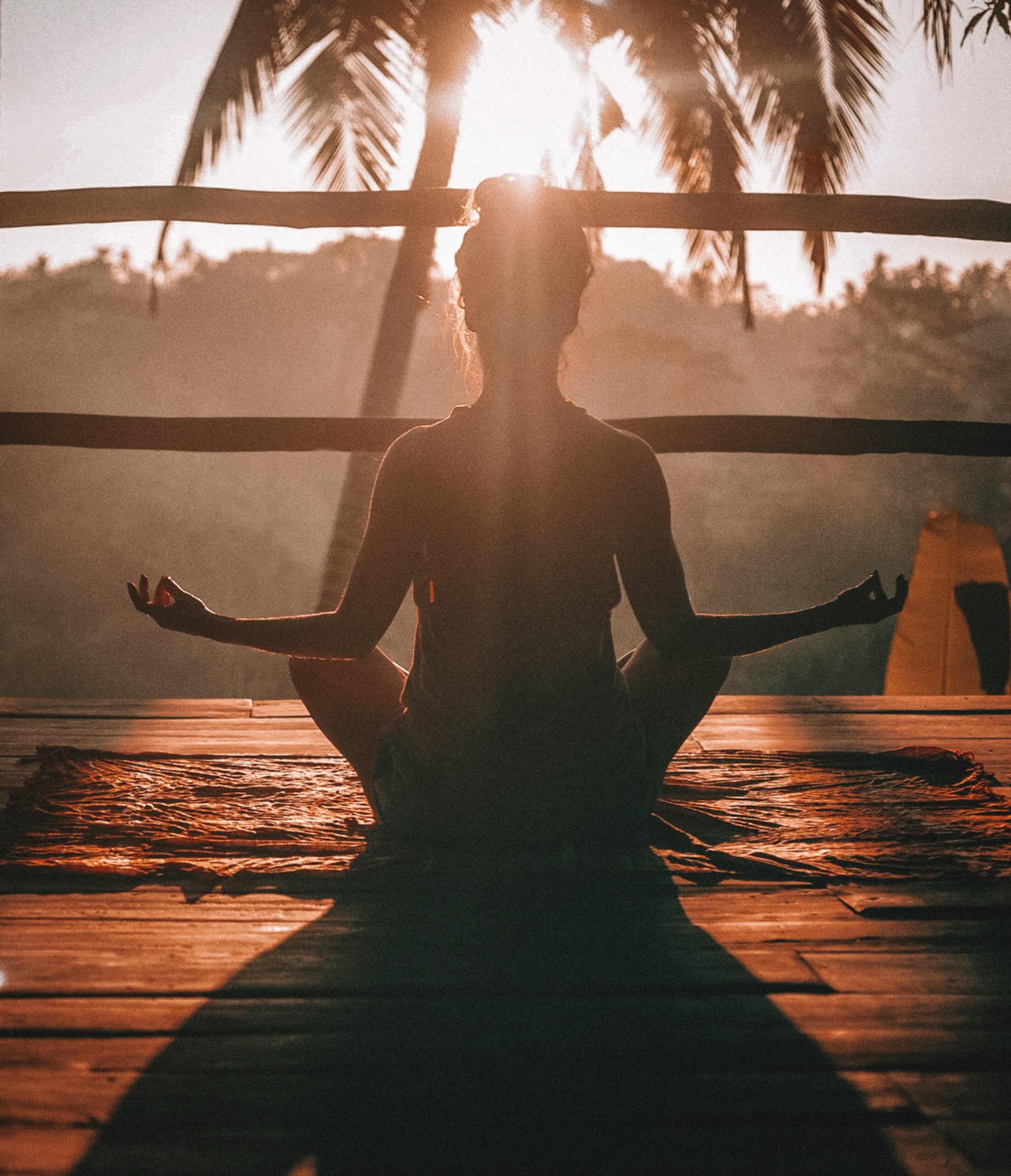 Woman practising yoga at sunrise
